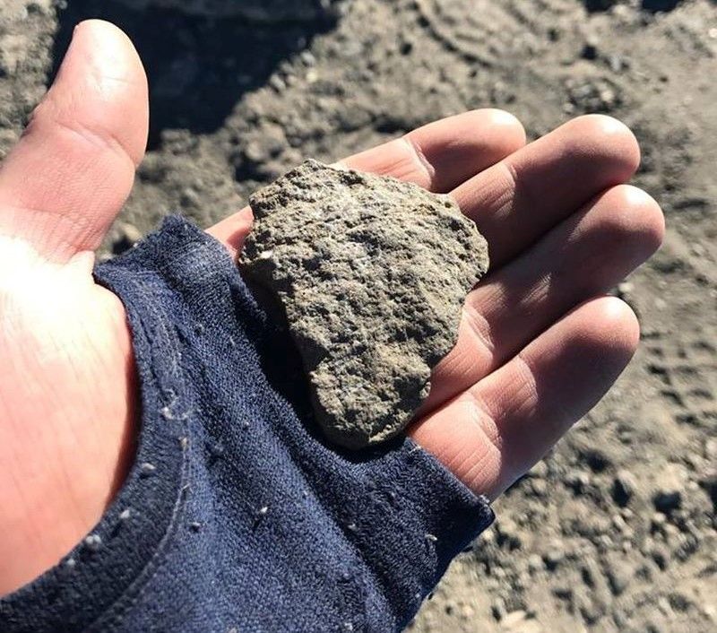 Placing a rock on the summit of Kilimanjaro