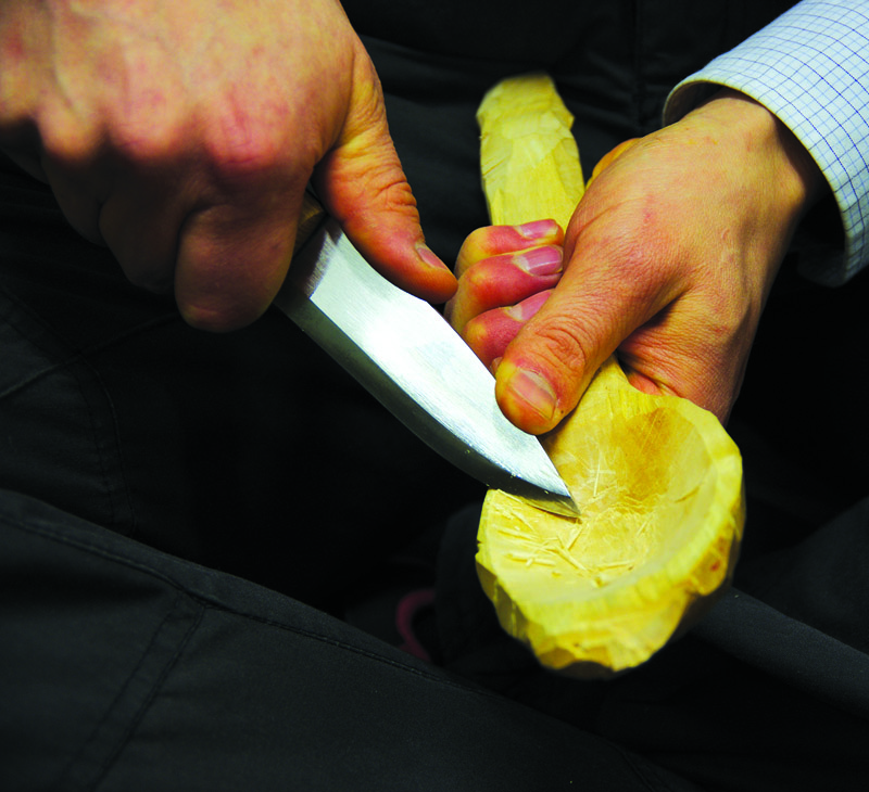 Carving a spoon with a knife