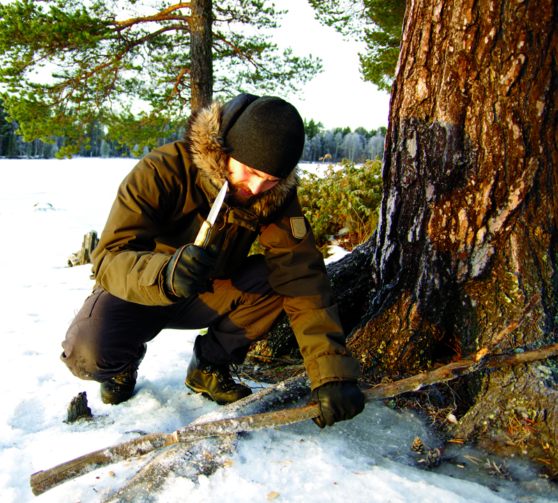 Chopping wood with a knife