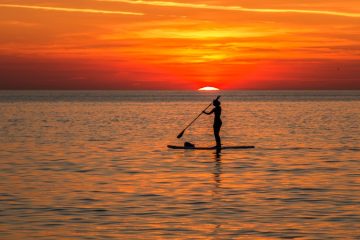 SUP boarding at sunset