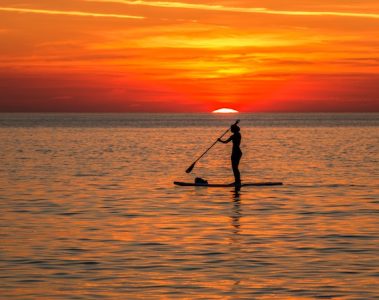 SUP boarding at sunset