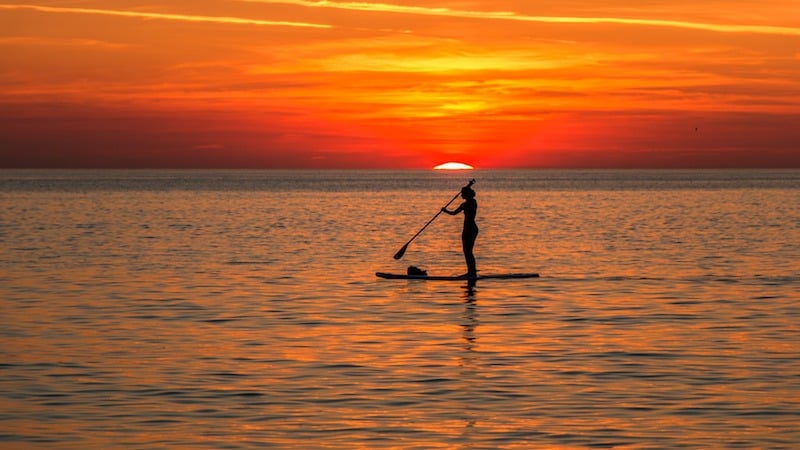 SUP boarding at sunset