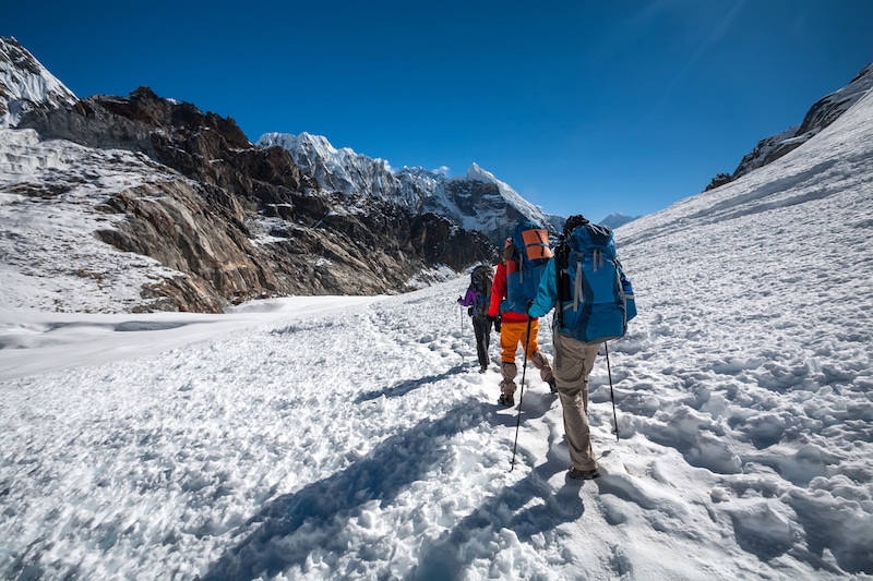 Trekkers crossing Cho La pass in Everest region, Nepal - winter adventures