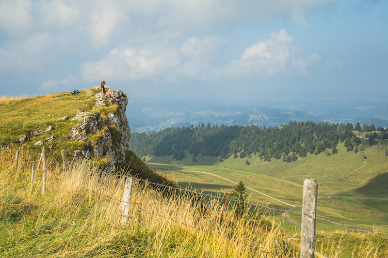 A hiker taking a break on stage eight of the Jura Crest Trail, Switzerland