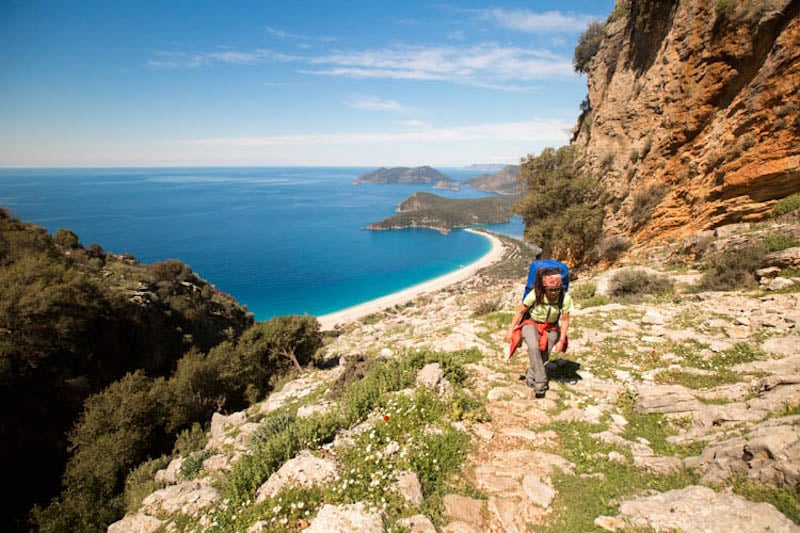 A hiker walking along a coastal path on the lycian way, turkey