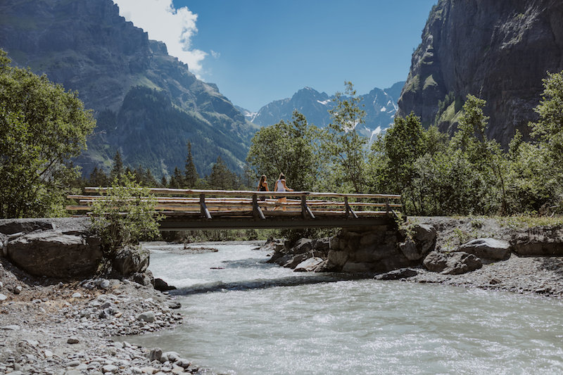 Hikers crossing a bridge in the Gastern Valley