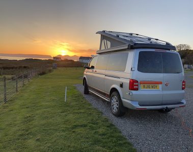 Campervan with a sunset on the west coast of Scotland