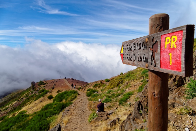 Footpath sign in Madeira above the clouds, one of the best hiking destinations for winter sun