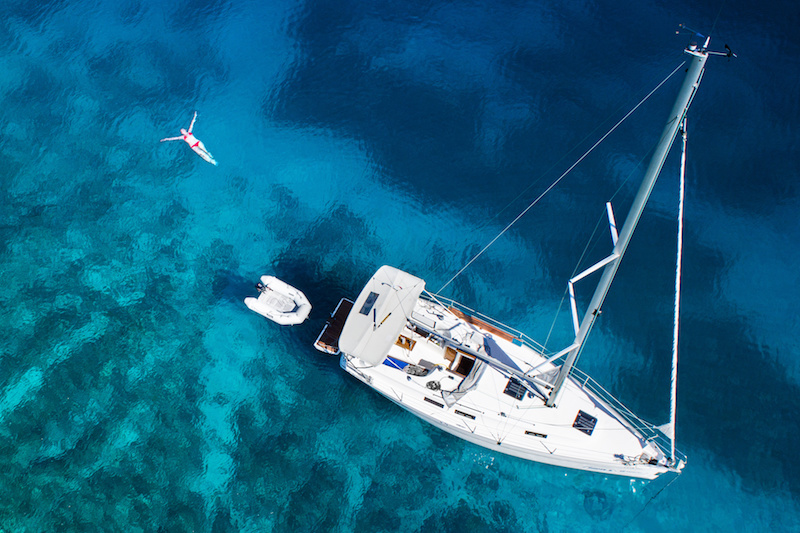 amazing view to yacht, swimming woman and clear water - Mediterranean paradise