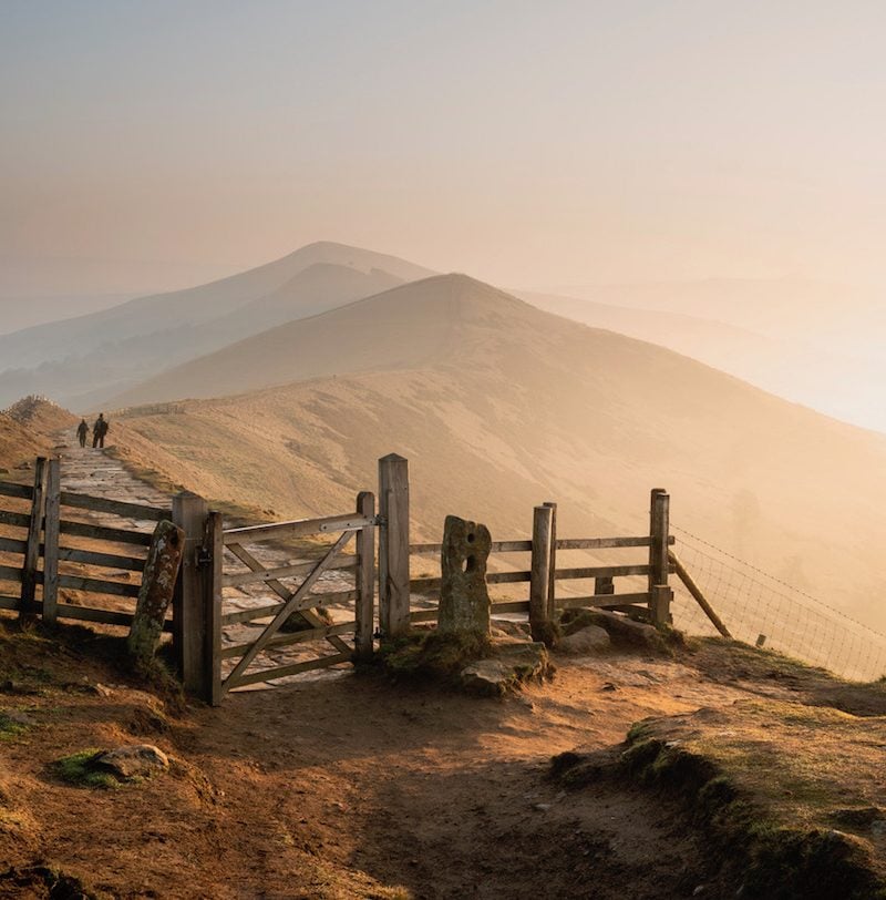 Beautiful Winter sunrise landscape image of The Great Ridge in the Peak District in England with mist hanging around the peaks