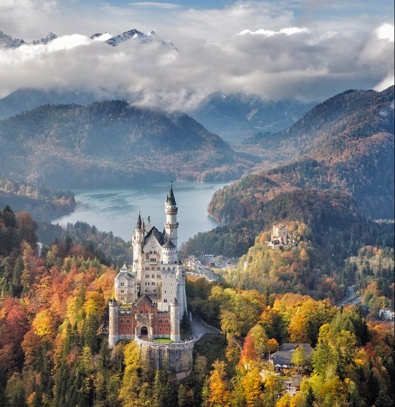 view of Neuschwanstein Castle on october 17th near Hohenschwangau, Germany during autumn afternoon surrounded by fall colours