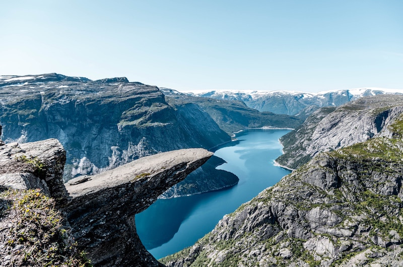 Best Norway hike. Cute girl with hiking equipment in the mountains