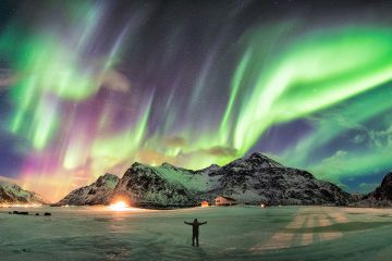Northern lights man looking up adventure travel show