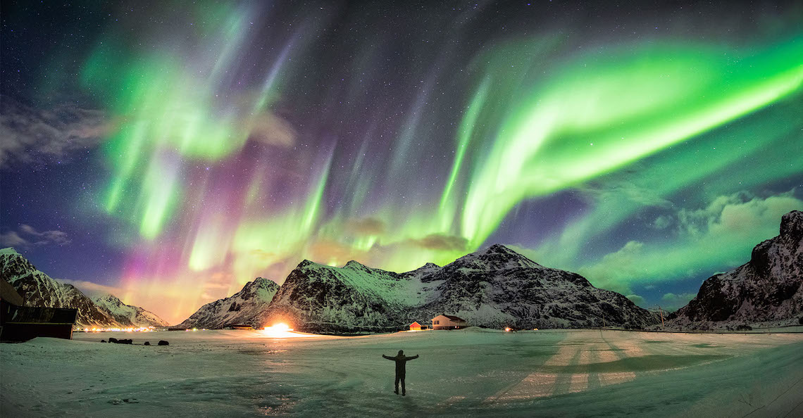 Northern lights man looking up adventure travel show