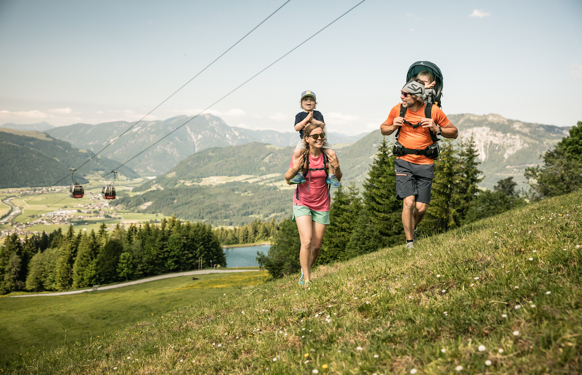 Family hiking up the hillside best things to do in St johann