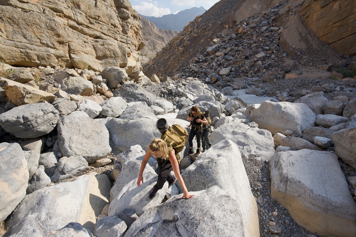 Clambering over boulders in the dry river bed