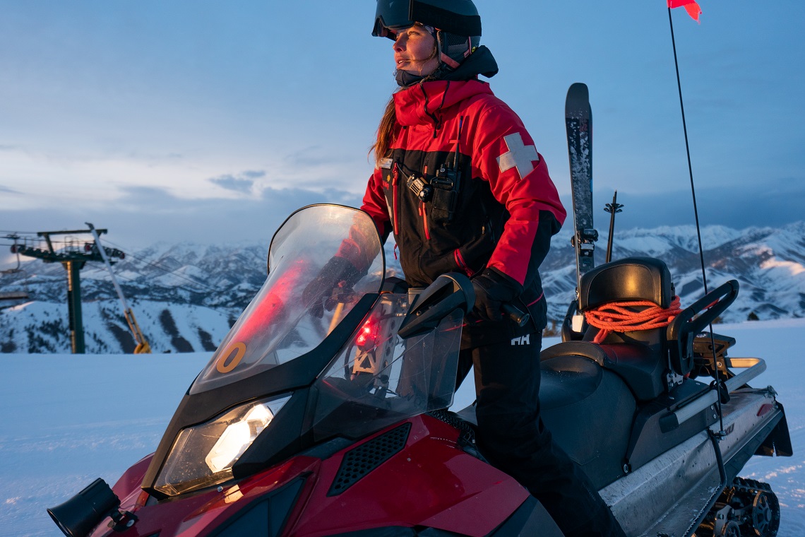 patrolling the slopes on the snow mobile